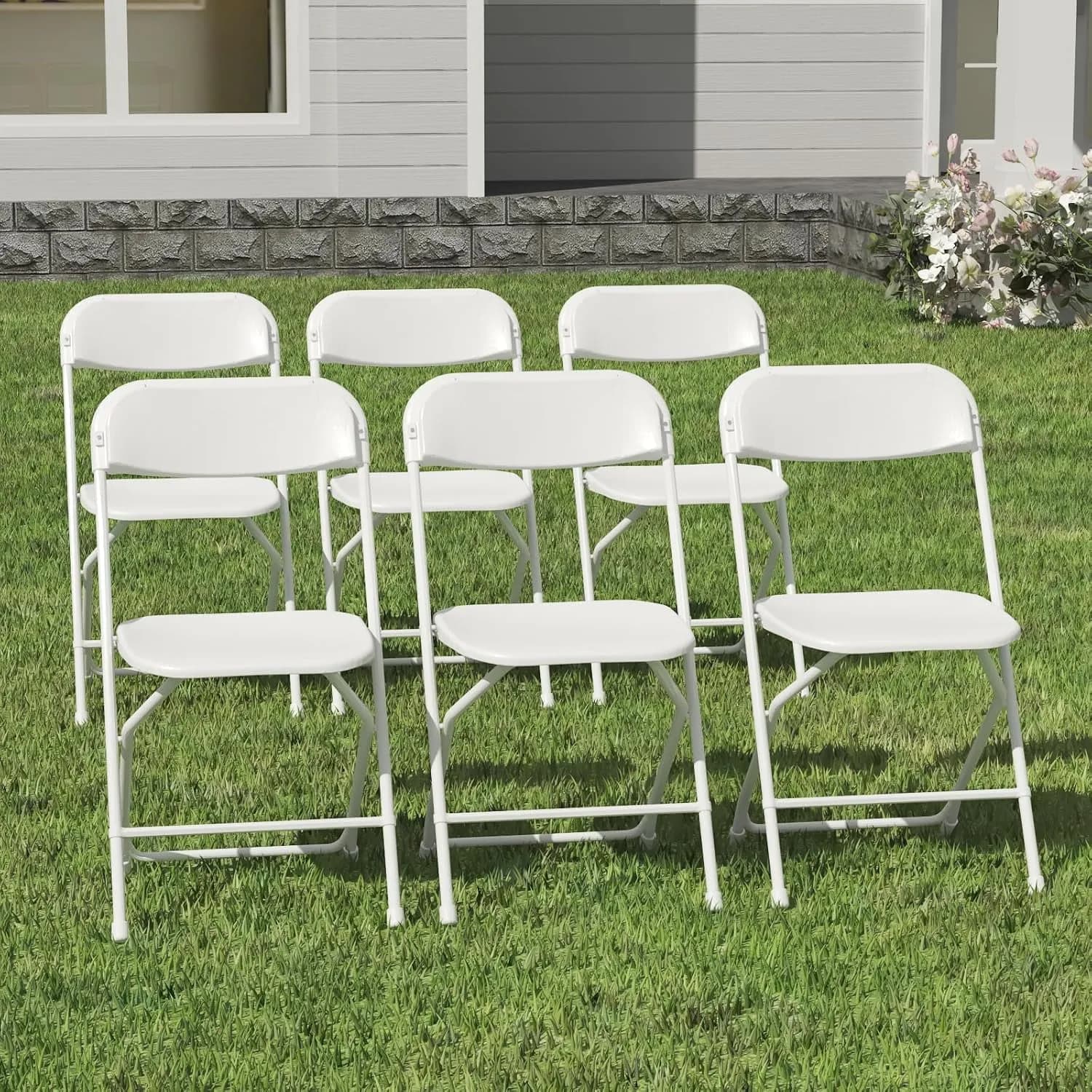 White folding chairs set out on a lawn
